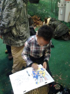 Kai is really into  sfinishing up to see his Skylander  drawing come alice 